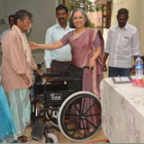 Donor&welwisher  of GOODWILL HANDS is distributing wheelchair to needy crippled leper during visit